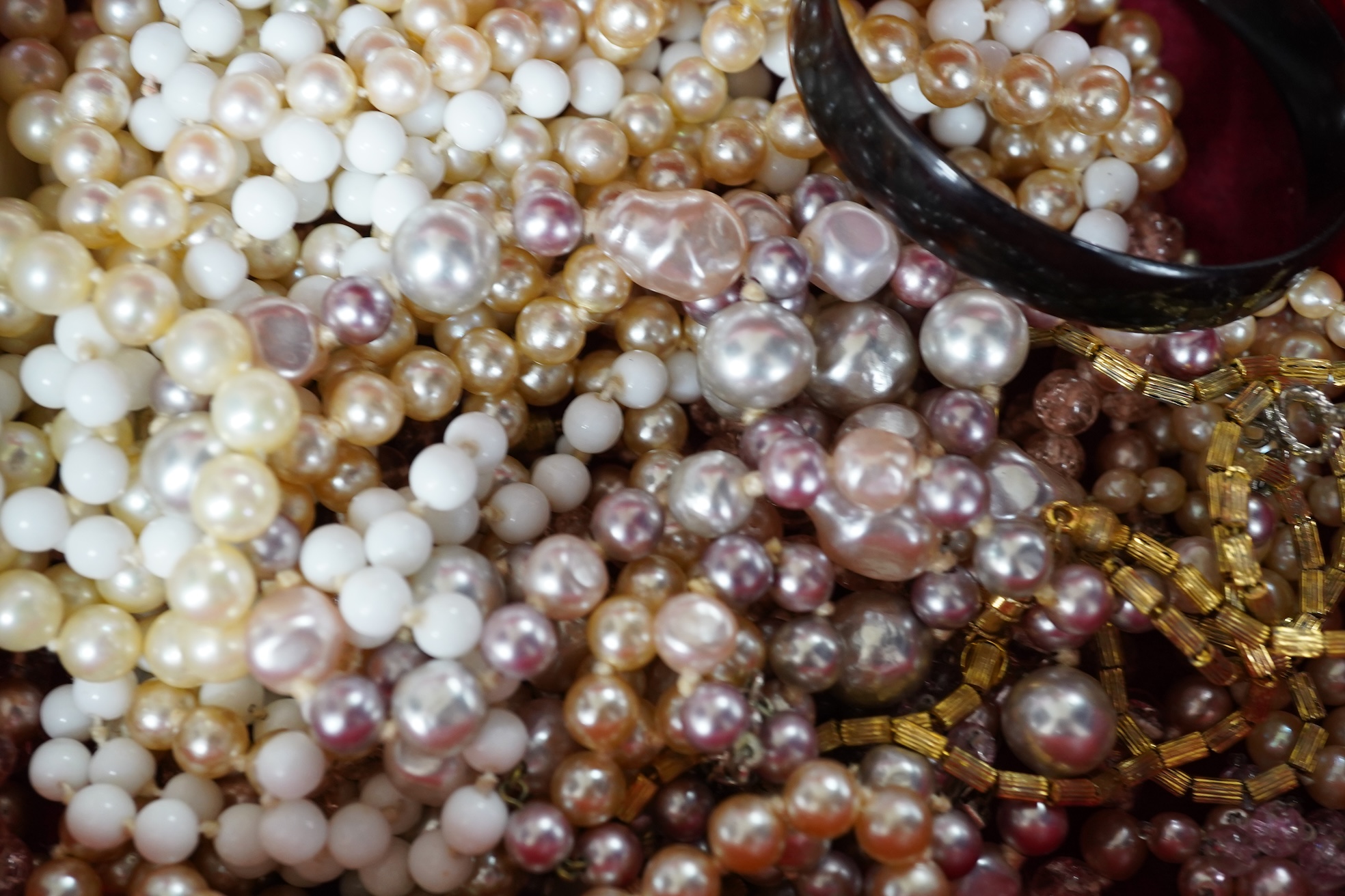 A lady's Retro gold watch by DelBana, 1940s, the square dial in a rose gold case accented with rubies, stamped 14K, to a black cord strap; together with a collection of assorted costume jewels, in a two-tiered white leat